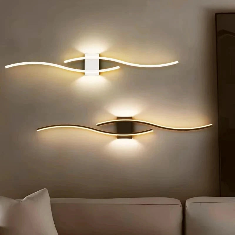 Curved wave LED wall lights mounted horizontally above a sofa in white and black