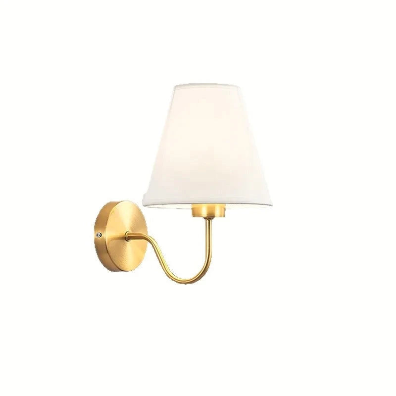 Linen shade wall sconce with curved brass arm on a plain background