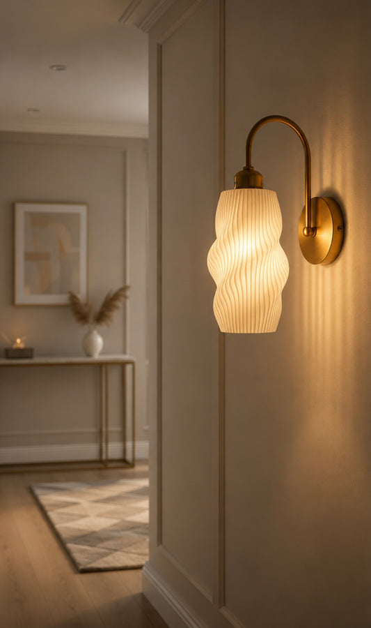Minimalist LED wall sconce mounted beside a bed casting soft ambient light